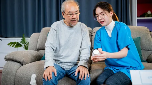 Asian senior man talking to healthcare provider