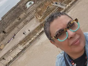 Photo of Maria in front of historic site