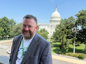 Man standing in front of U.S. Capitol Building.