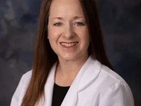 Photo of woman in white coat