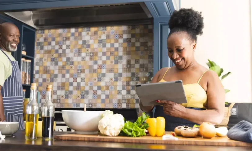 Happy African American couple in kitchen preparing a meal