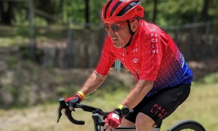 Don riding a bicycle on a road
