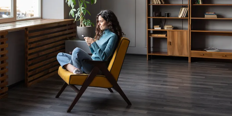 Woman sitting in chair shopping on her smartphone