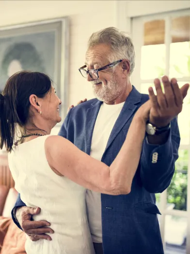 Mature couple dancing together indoors